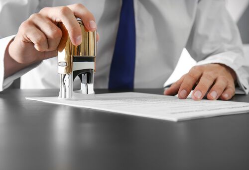 A certified signing agent completing a notarization
