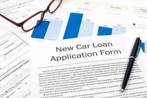 Reviewing a new car loan application with a signing agent