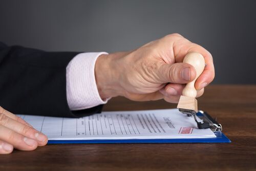 A signing agent stamping notarized documents