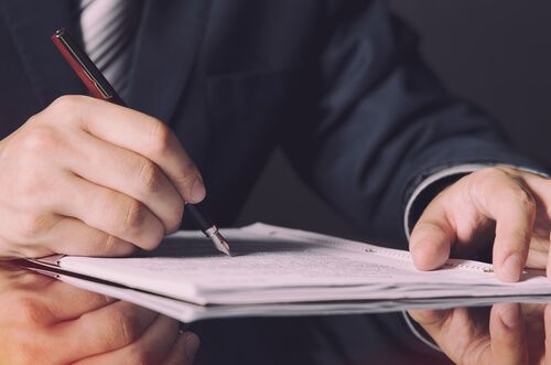 A notary signing documents after hours
