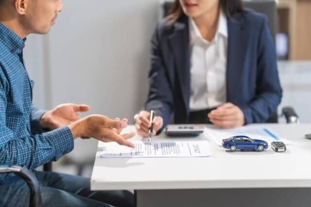 A signing agent walking a client through documents